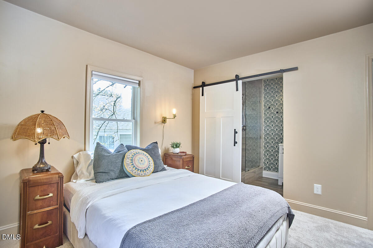 214 Moline Street Durham, NC 27707 - Photo 27 of 49 a bedroom with a bed and a chandelier