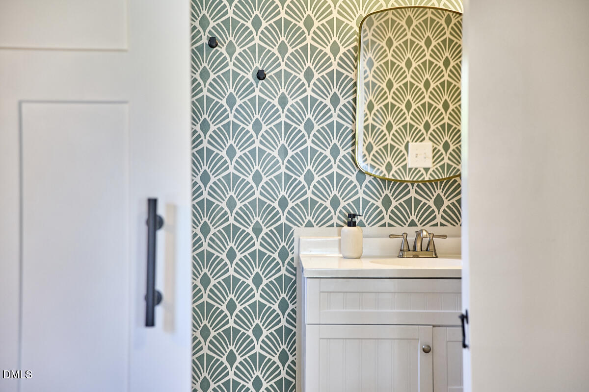214 Moline Street Durham, NC 27707 - Photo 28 of 49 a bathroom with a sink and a mirror