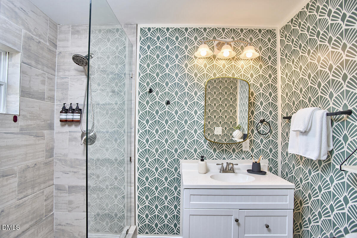 214 Moline Street Durham, NC 27707 - Photo 29 of 49 a bathroom with a sink mirror and vanity