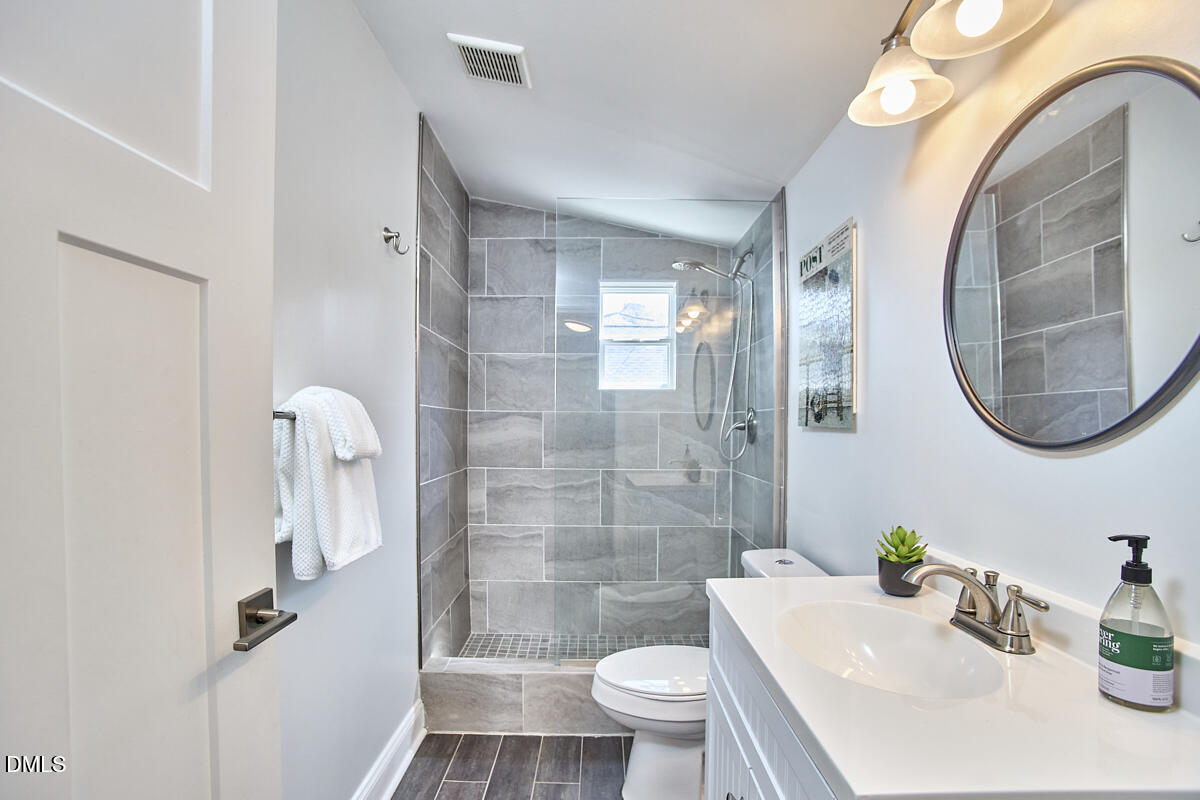 214 Moline Street Durham, NC 27707 - Photo 34 of 49 a bathroom with a sink toilet and shower
