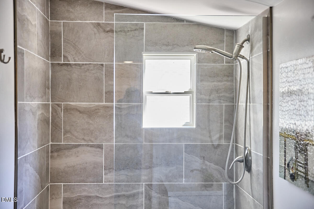 214 Moline Street Durham, NC 27707 - Photo 35 of 49 a bathroom with a glass shower door