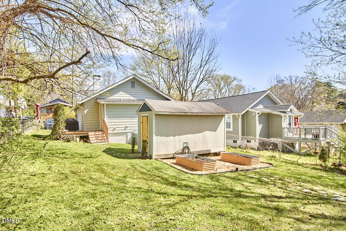 214 Moline Street Durham, NC 27707 - Photo 45 of 49 a front view of a house with a yard table and chairs
