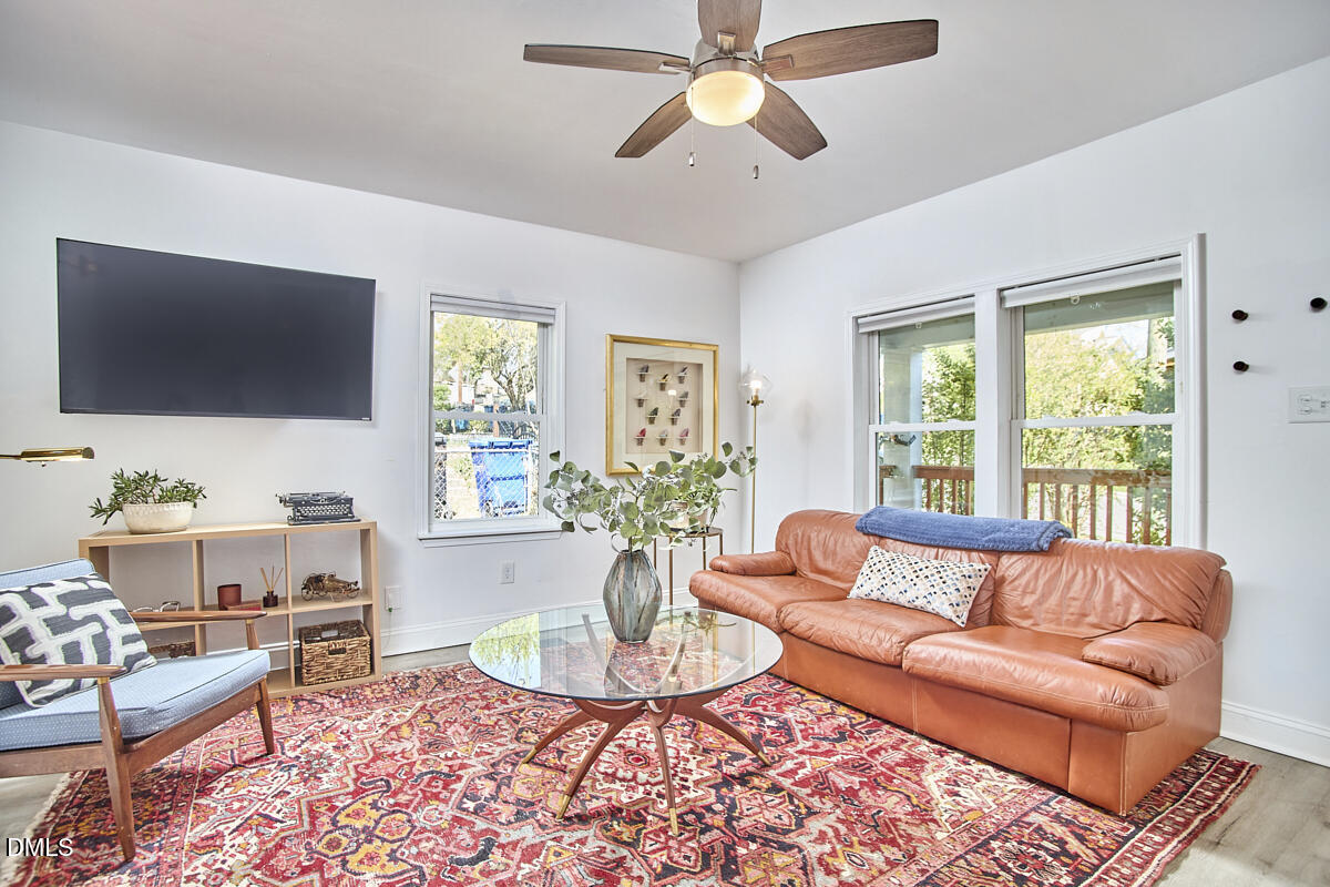 214 Moline Street Durham, NC 27707 - Photo 9 of 49 a living room with furniture a flat screen tv and a large window