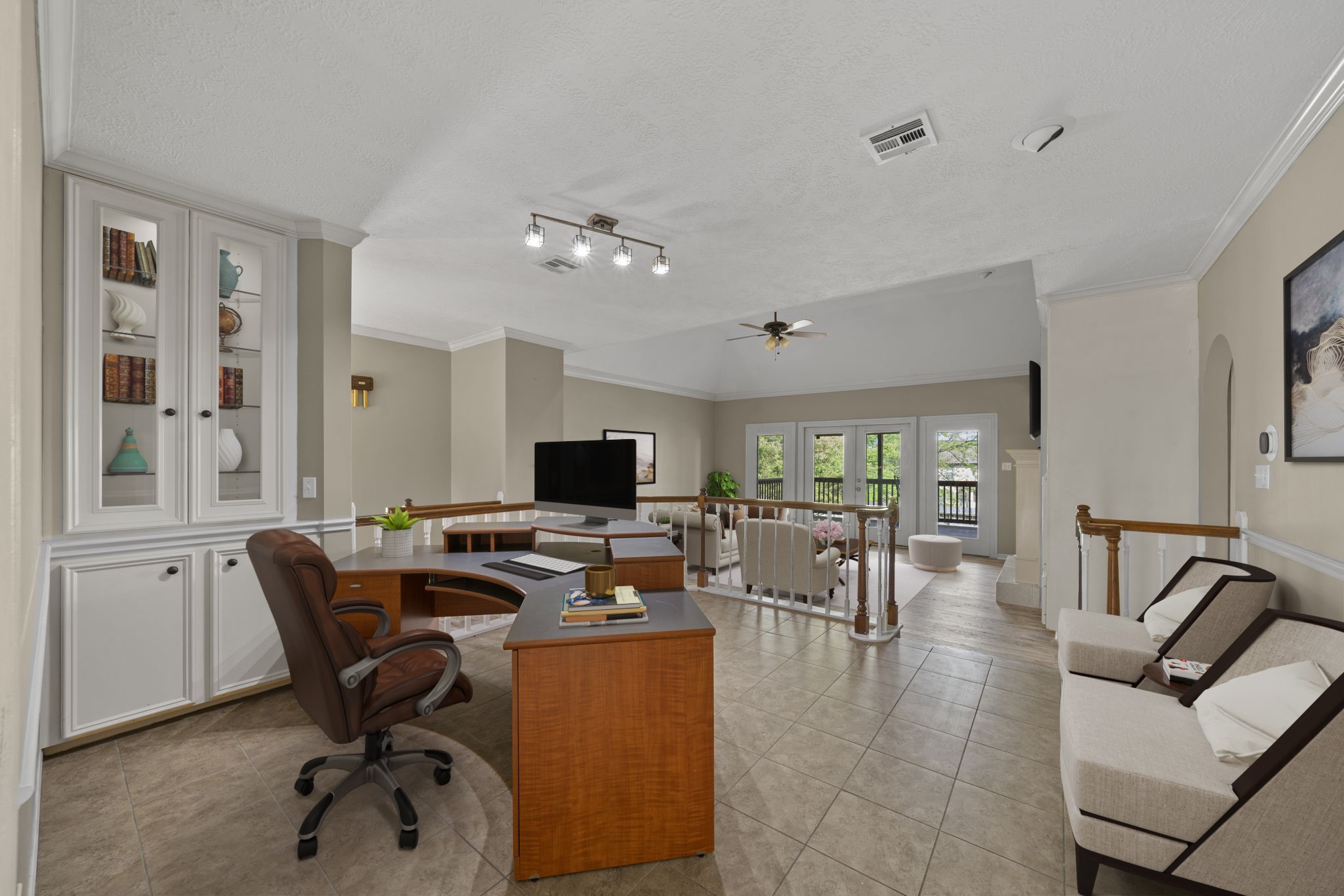 169 April Cove Montgomery, TX 77356 - Photo 25 of 39 Virtually Staged: Versatile open-concept space featuring tile flooring, crown molding, and abundant natural light. Complete with built-in cabinetry and a dedicated workspace, this area seamlessly connects to the living space and offers flexibility for a home office or study.