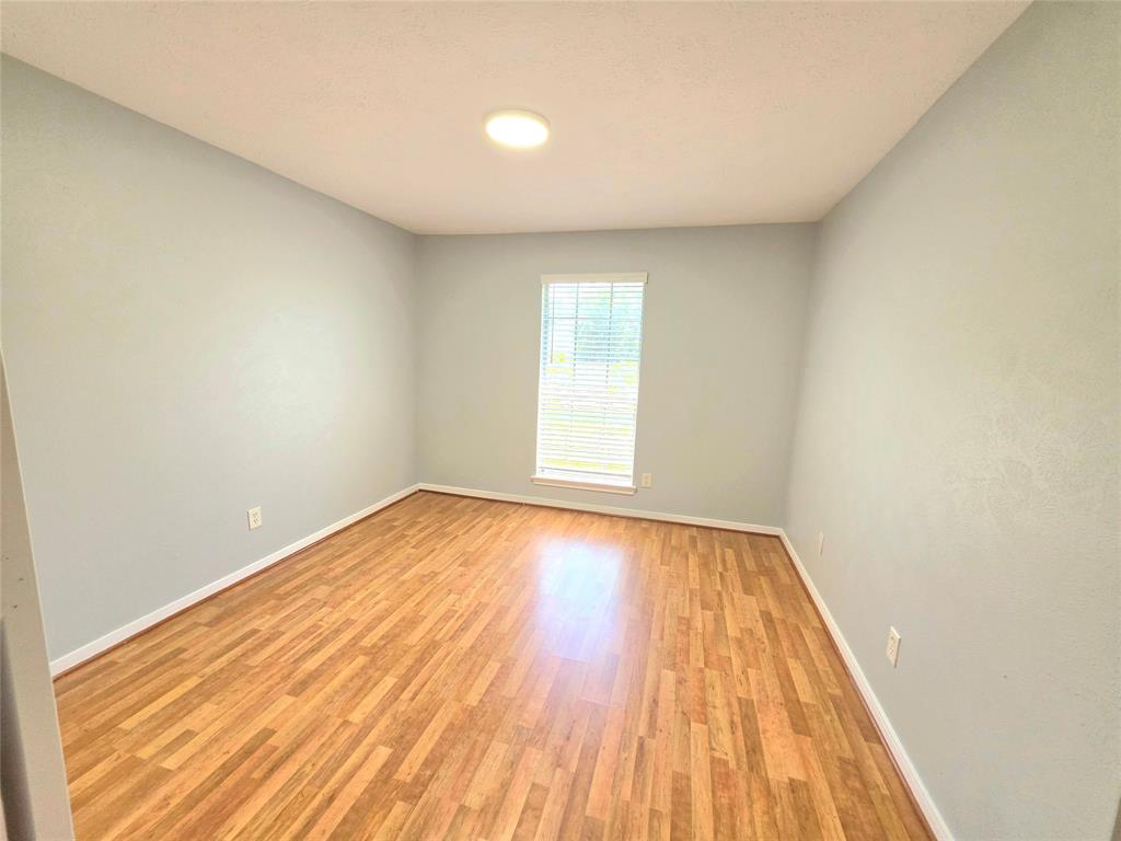13618 Sablegrove Lane Houston, TX 77014 - Photo 23 of 30 a view of empty room with wooden floor