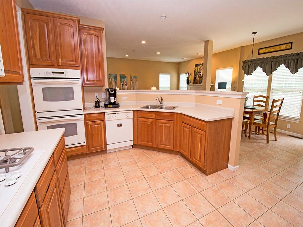 215 Cliffside Drive Mars, PA 16046 - Photo 14 of 23 a large kitchen with stainless steel appliances granite countertop a stove top oven a sink dishwasher and white cabinets