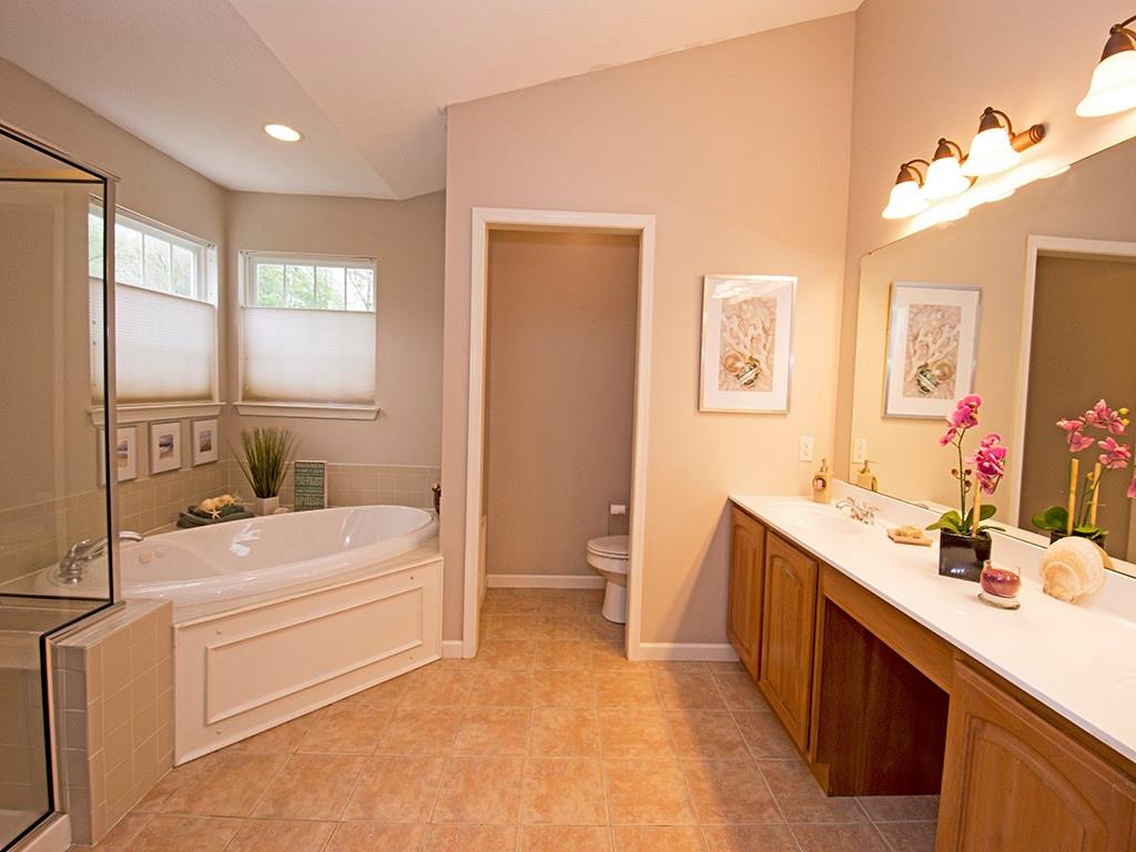 215 Cliffside Drive Mars, PA 16046 - Photo 17 of 23 a bathroom with a double vanity sink a toilet a mirror and shower