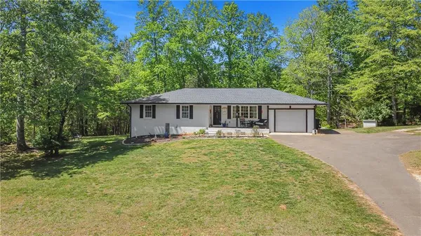 an aerial view of a house with a yard