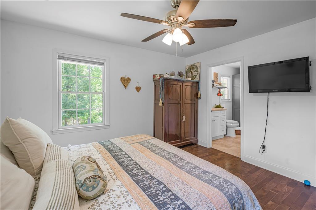 2383 Sperin Road Ball Ground, GA 30107 - Photo 11 of 38 a spacious bedroom with a bed and a flat screen tv