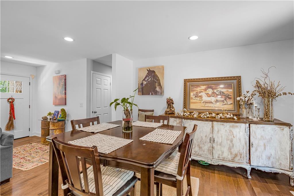 2383 Sperin Road Ball Ground, GA 30107 - Photo 10 of 38 a view of a dining room with furniture a chandelier and wooden floor