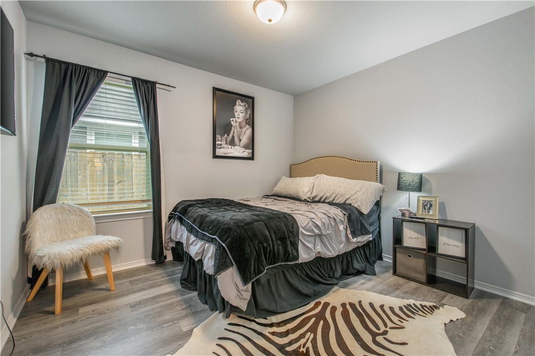 2850 Messenger Way Bryan, TX 77803 - Photo 12 of 17 a bedroom with a bed and wooden floor