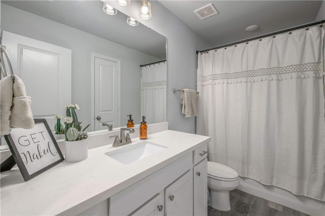 2850 Messenger Way Bryan, TX 77803 - Photo 14 of 17 a bathroom with a sink a toilet and shower curtain