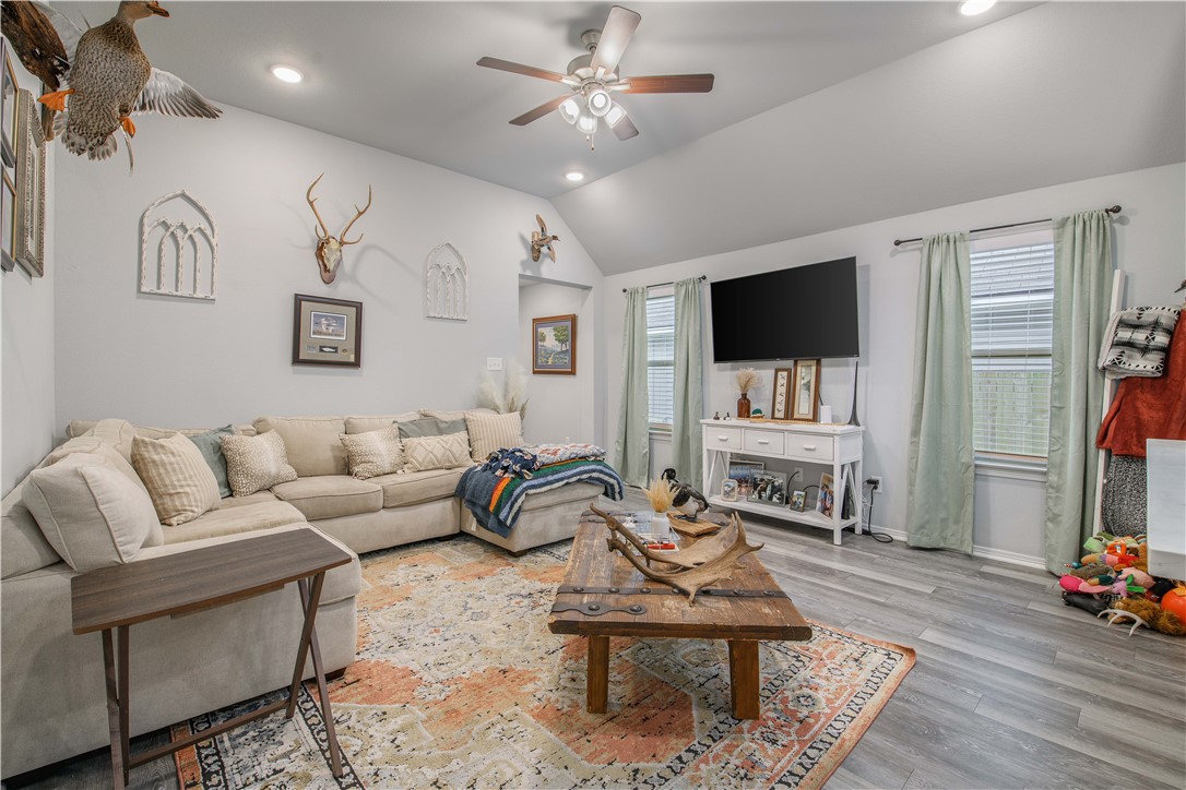 2850 Messenger Way Bryan, TX 77803 - Photo 5 of 17 a living room with furniture a flat screen tv and a fireplace