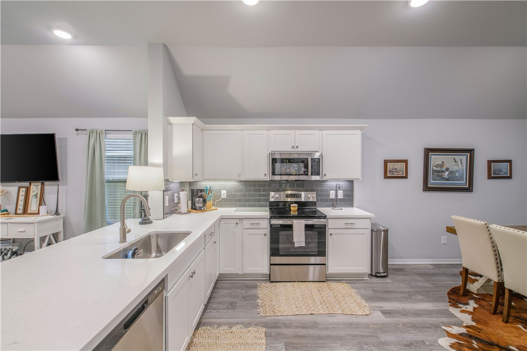 2850 Messenger Way Bryan, TX 77803 - Photo 7 of 17 a kitchen with stainless steel appliances granite countertop a sink dishwasher stove top oven and refrigerator