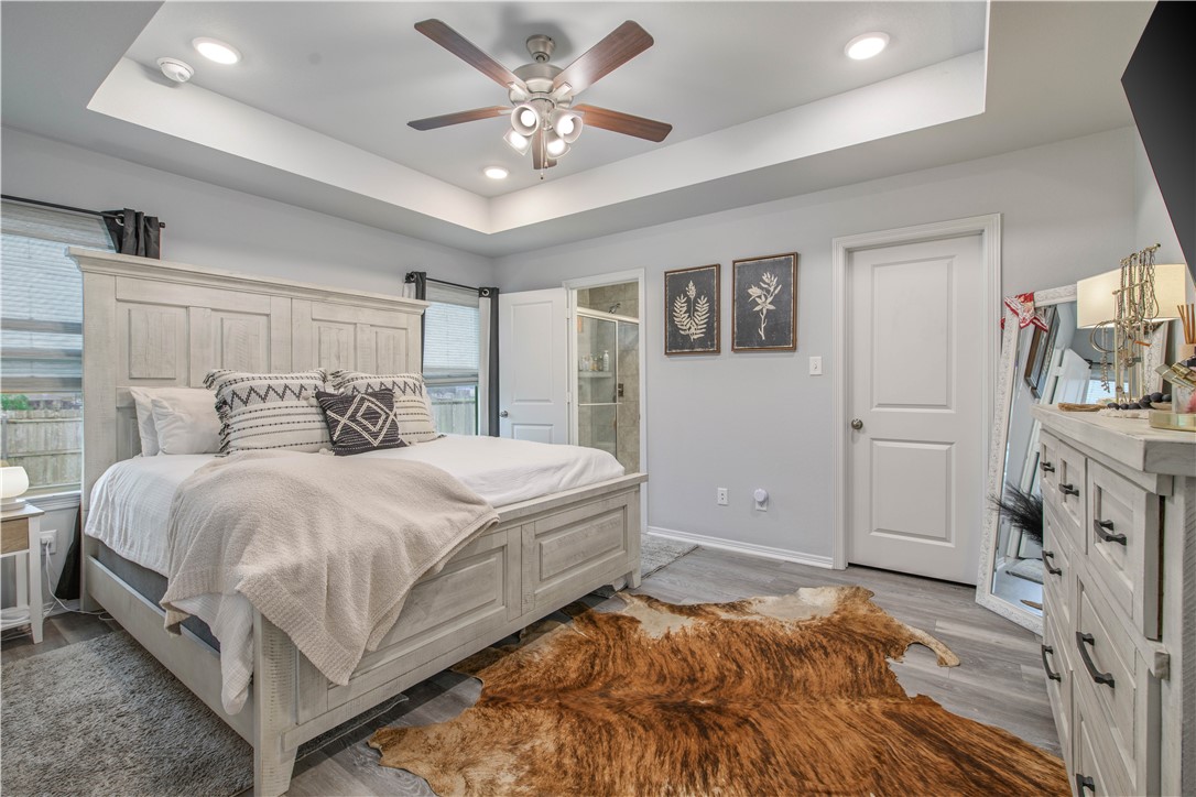 2850 Messenger Way Bryan, TX 77803 - Photo 9 of 17 a bedroom with a bed and a chandelier