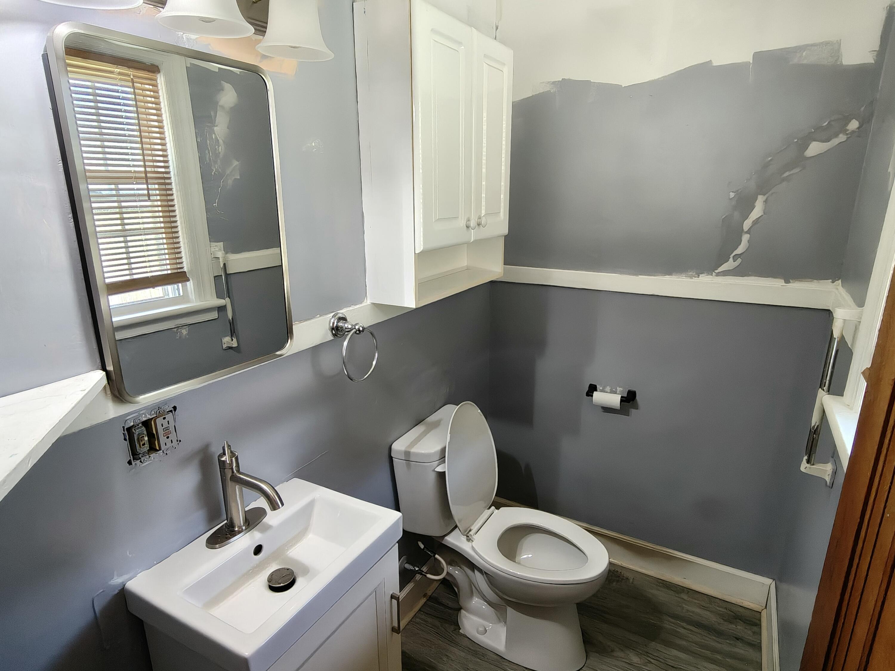 245 North Indiana Street Griffith, IN 46319 - Photo 10 of 30 a bathroom with a toilet sink and mirror