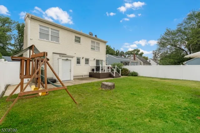 a view of a house with a backyard