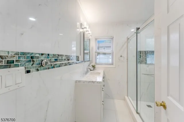 a bathroom with a double vanity sink a mirror and shower