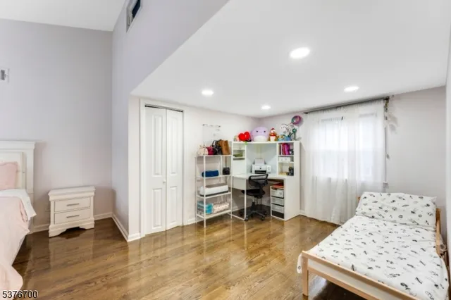 a bedroom with a bed and a couch