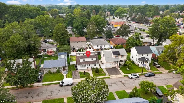 an aerial view of residential houses with outdoor space and street view
