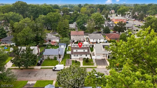 an aerial view of residential houses with outdoor space and street view