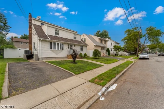 a view of a house with a backyard