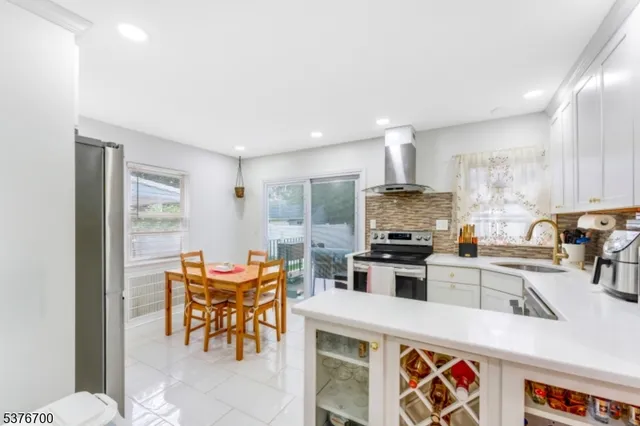 a kitchen with stainless steel appliances granite countertop a stove top oven a sink and dishwasher