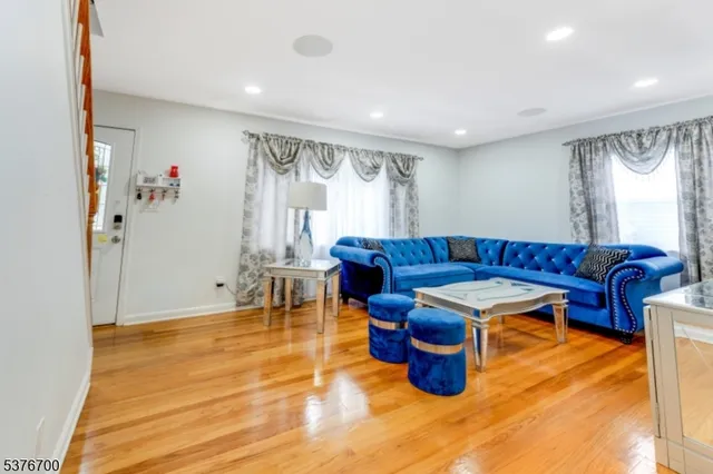 a living room with furniture a rug and a window