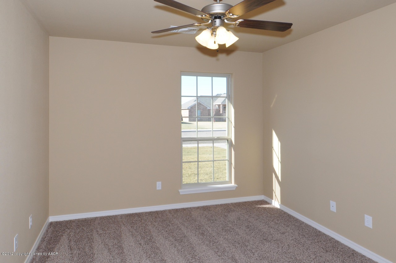 5903 South Rusk Street Amarillo, TX 79118 - Photo 11 of 16 an empty room with windows and fan