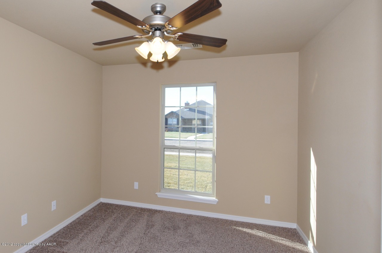 5903 South Rusk Street Amarillo, TX 79118 - Photo 12 of 16 an empty room with windows and chandelier fan