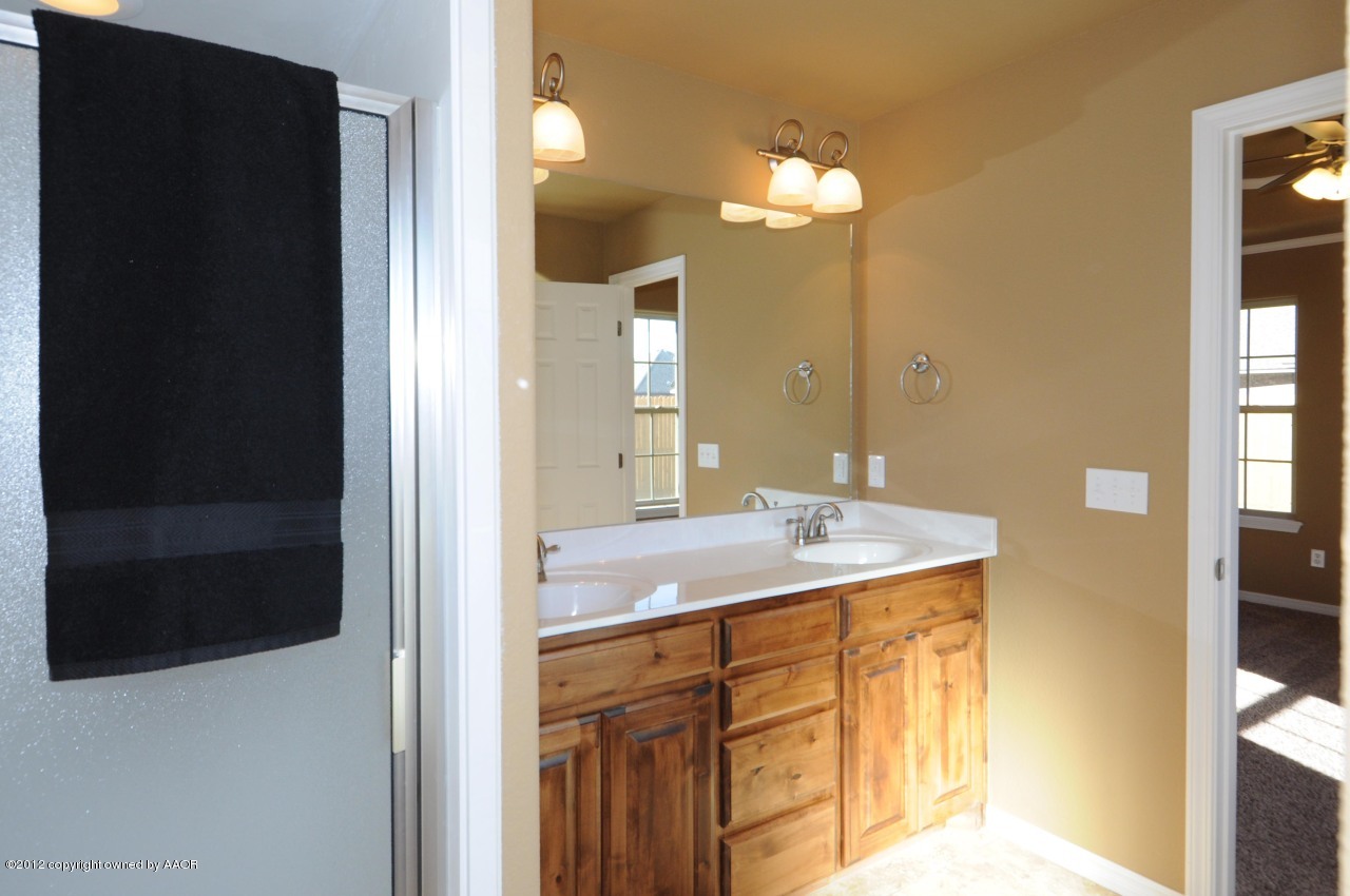 5903 South Rusk Street Amarillo, TX 79118 - Photo 14 of 16 a bathroom with a sink and a mirror