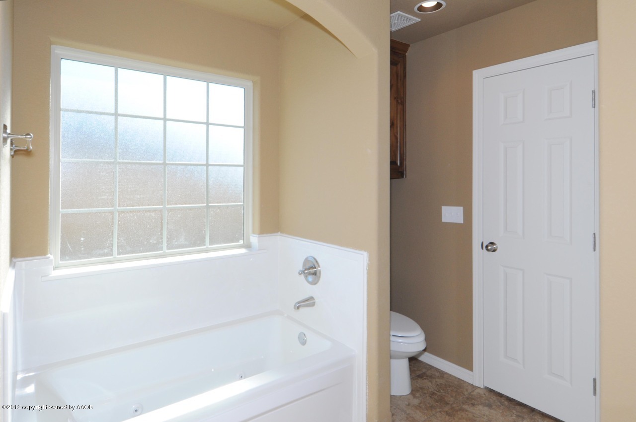 5903 South Rusk Street Amarillo, TX 79118 - Photo 15 of 16 a bathroom with a bathtub and a toilet