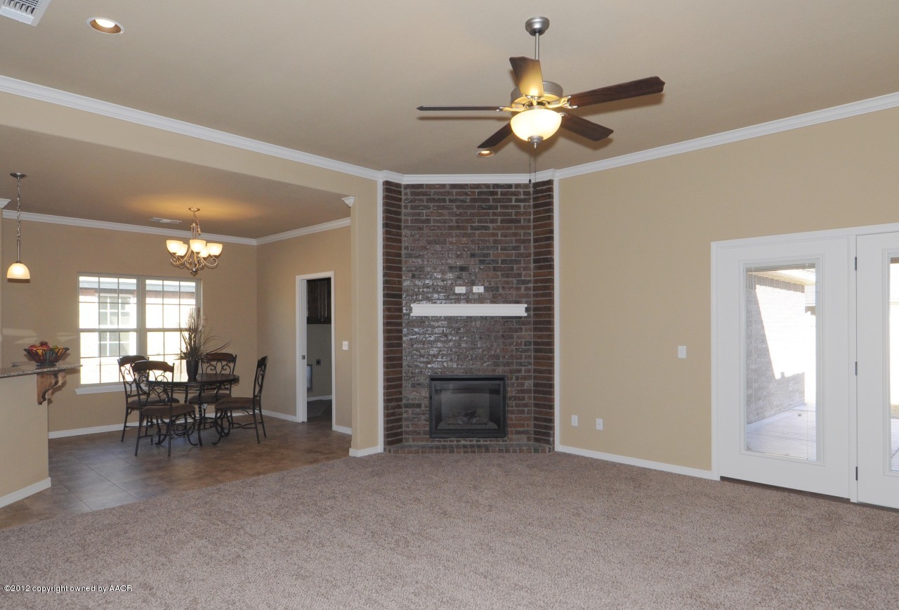 5903 South Rusk Street Amarillo, TX 79118 - Photo 3 of 16 a view of a livingroom with furniture chandelier fan and kitchen view