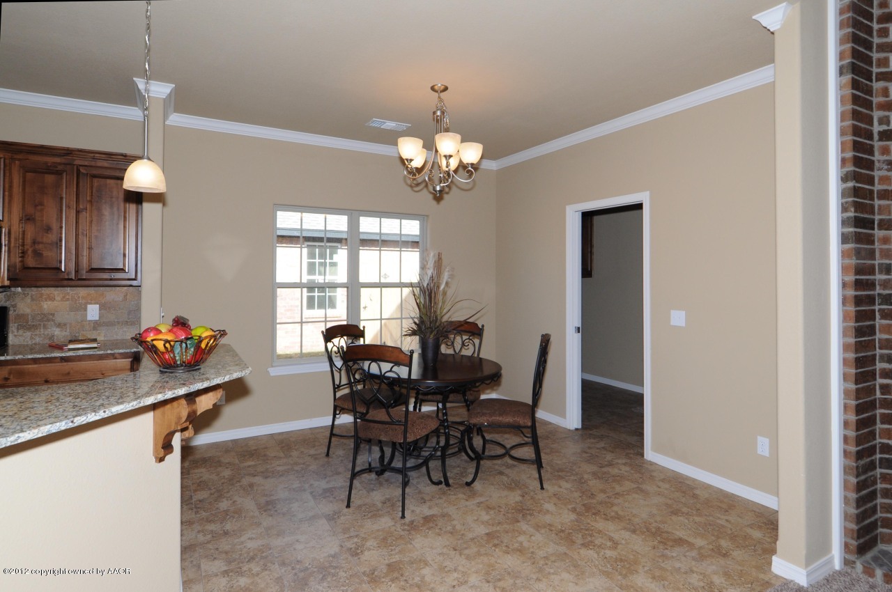 5903 South Rusk Street Amarillo, TX 79118 - Photo 4 of 16 a view of a dining room with furniture and chandelier
