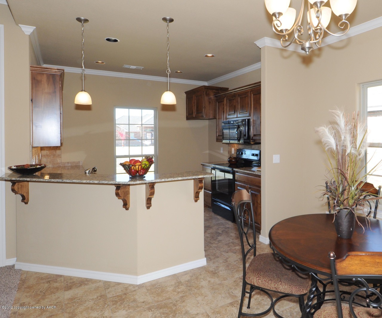 5903 South Rusk Street Amarillo, TX 79118 - Photo 5 of 16 a kitchen with a table chairs and a chandelier