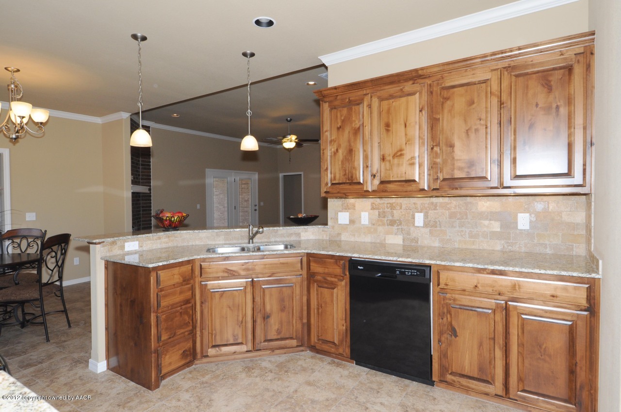 5903 South Rusk Street Amarillo, TX 79118 - Photo 7 of 16 a kitchen with a sink and cabinets