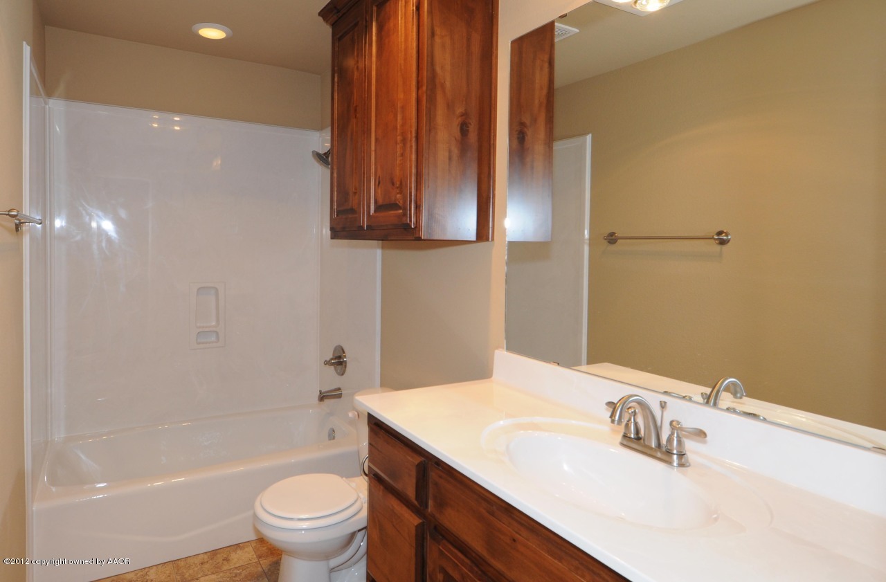 5903 South Rusk Street Amarillo, TX 79118 - Photo 9 of 16 a bathroom with a sink a toilet and shower