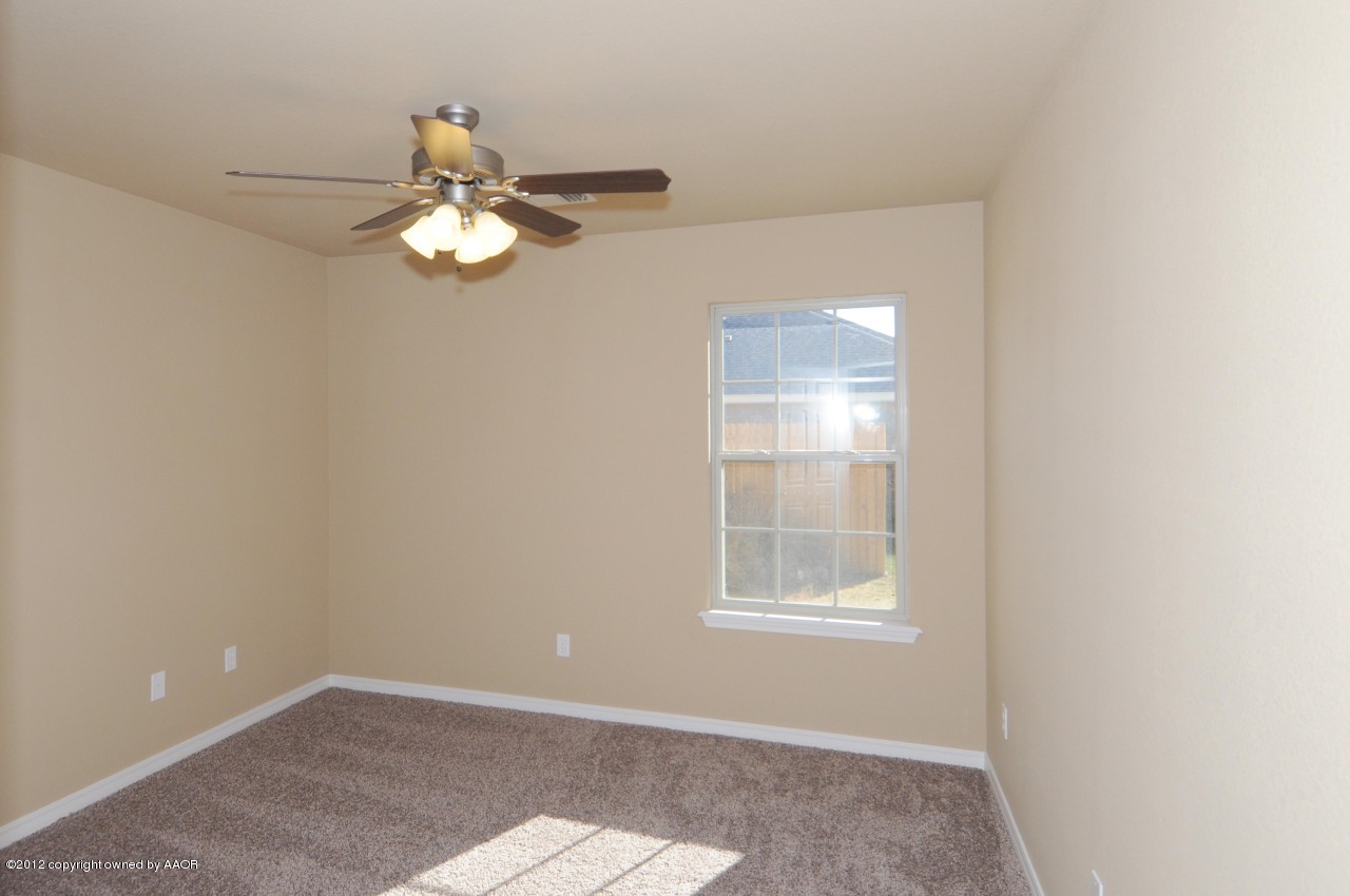5903 South Rusk Street Amarillo, TX 79118 - Photo 10 of 16 an empty room with windows and fan