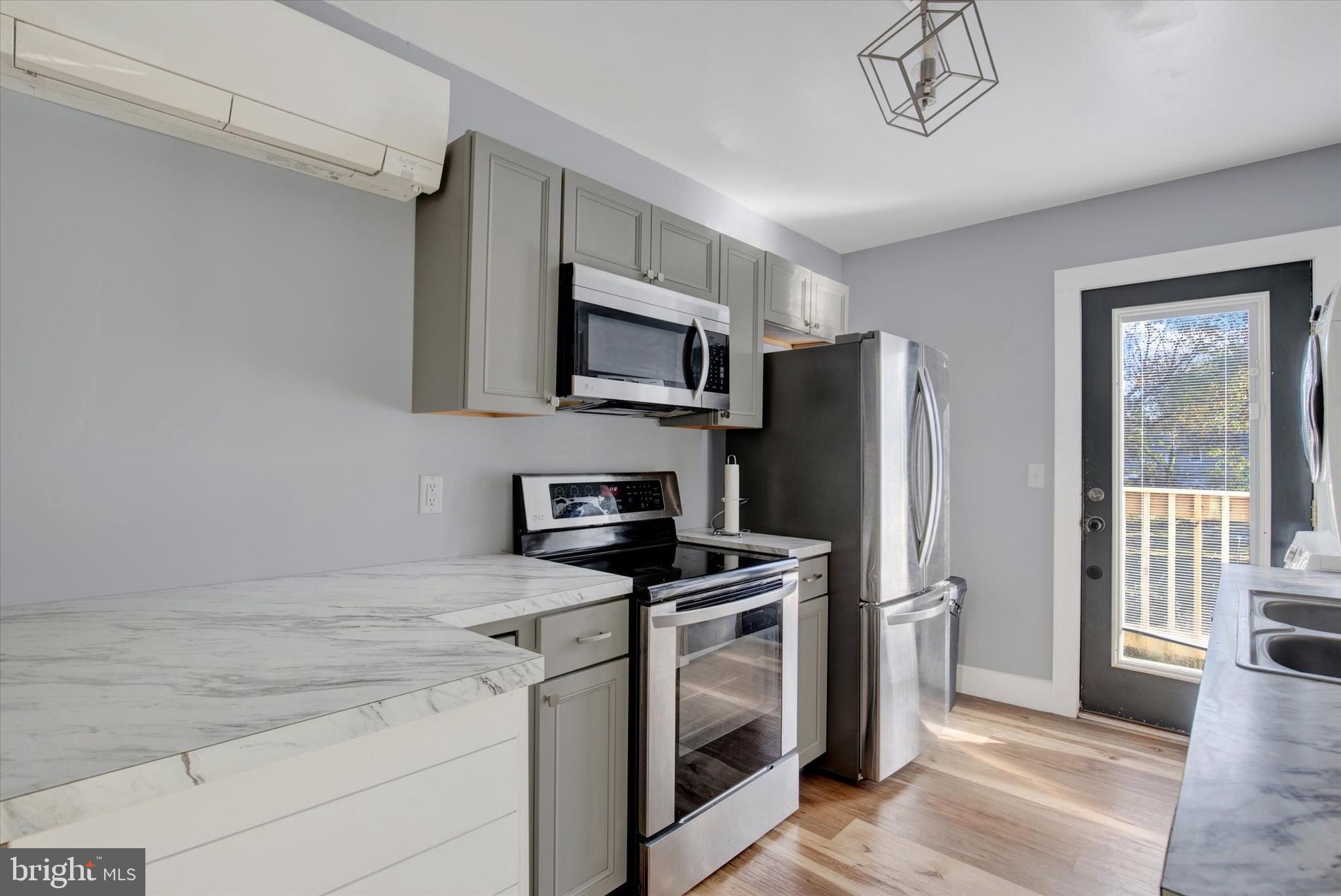 603 Ferry Street Sharptown, MD 21861 - Photo 11 of 28 a kitchen with stainless steel appliances a stove a refrigerator and a microwave