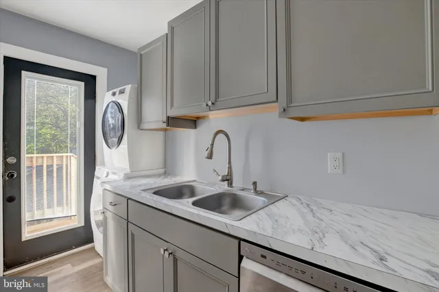 a close view of sink a washer and dryer