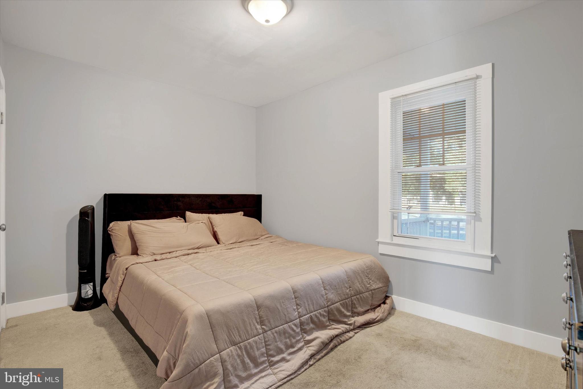 603 Ferry Street Sharptown, MD 21861 - Photo 15 of 28 a large bed sitting in a bedroom next to a window