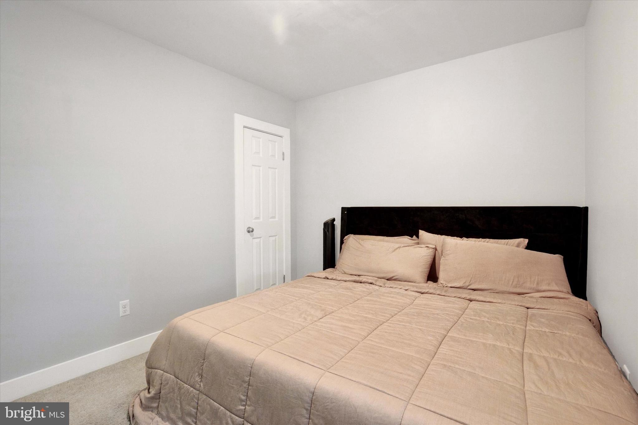 603 Ferry Street Sharptown, MD 21861 - Photo 16 of 28 a bedroom with a large bed and a lamp
