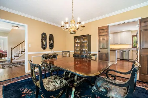 a view of a dining room with furniture and a chandelier