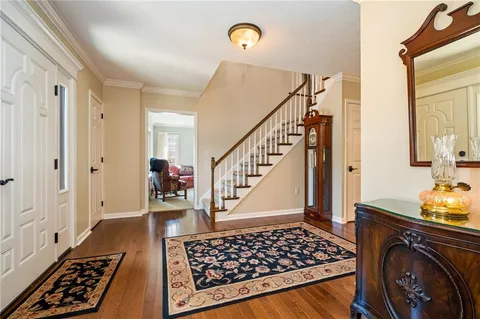 a view of a hallway with wooden floor and cabinets
