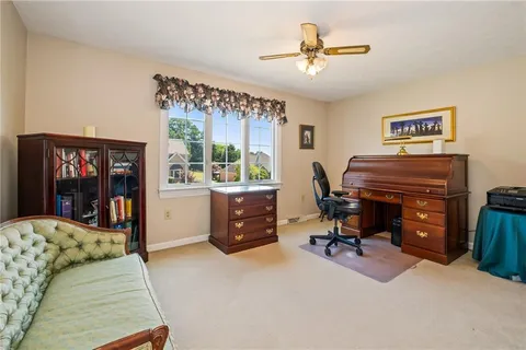 a view of a livingroom with workspace and a window