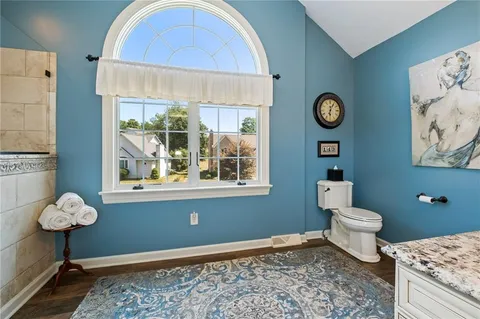 a bathroom with a toilet sink and mirror