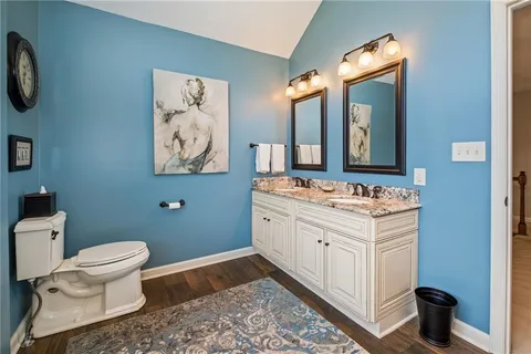 a bathroom with a toilet sink and mirror