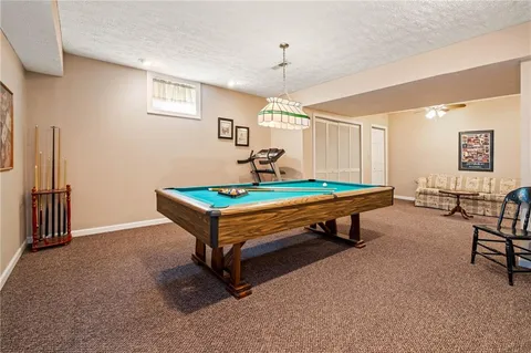 a view of a livingroom with furniture and a floor to ceiling window