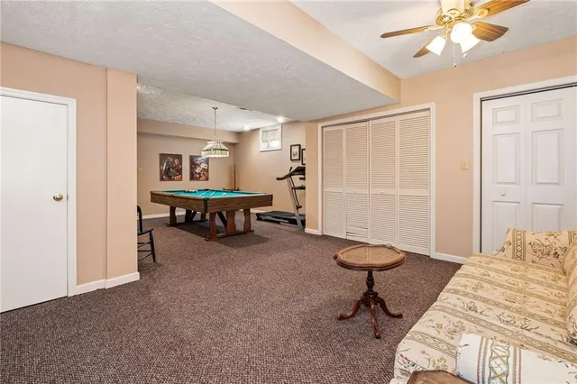 a room with pool table and windows