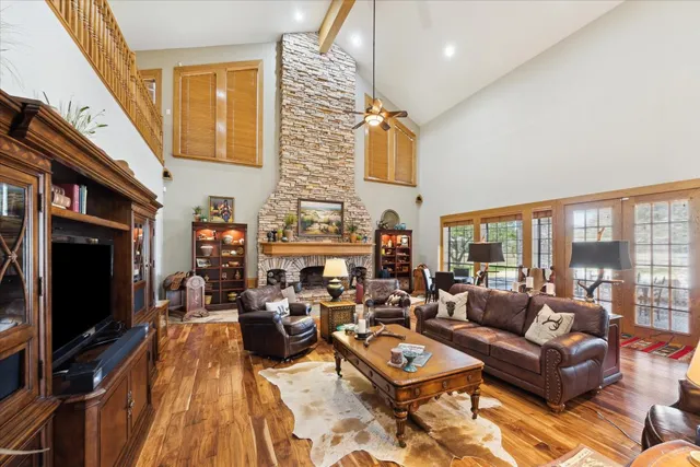 a living room with fireplace furniture and a large window